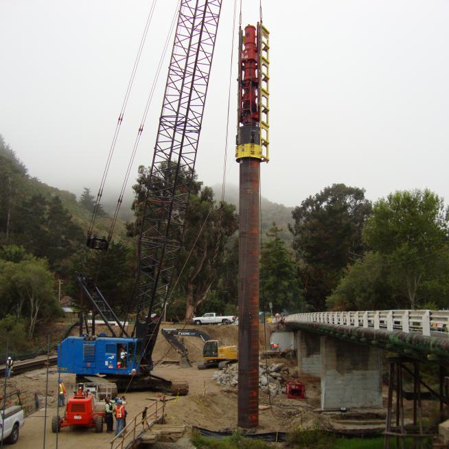crane hoisting a piling
