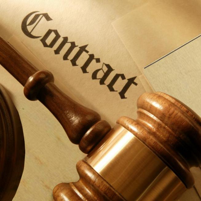 Image of a gavel resting on a contract