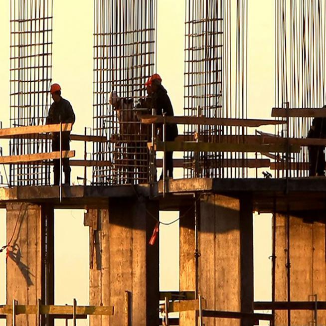 construction workers with rebar towers