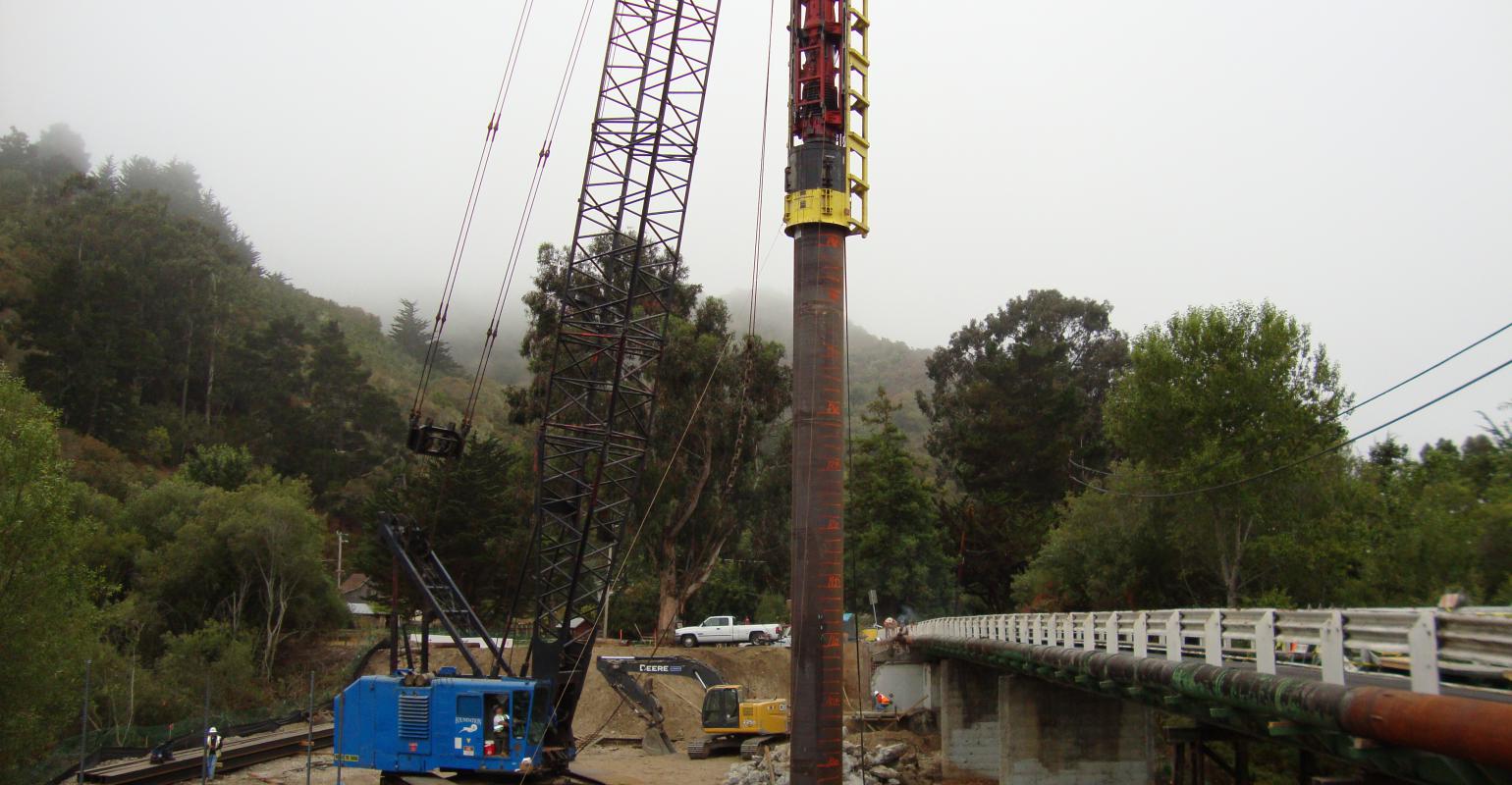 crane hoisting a piling
