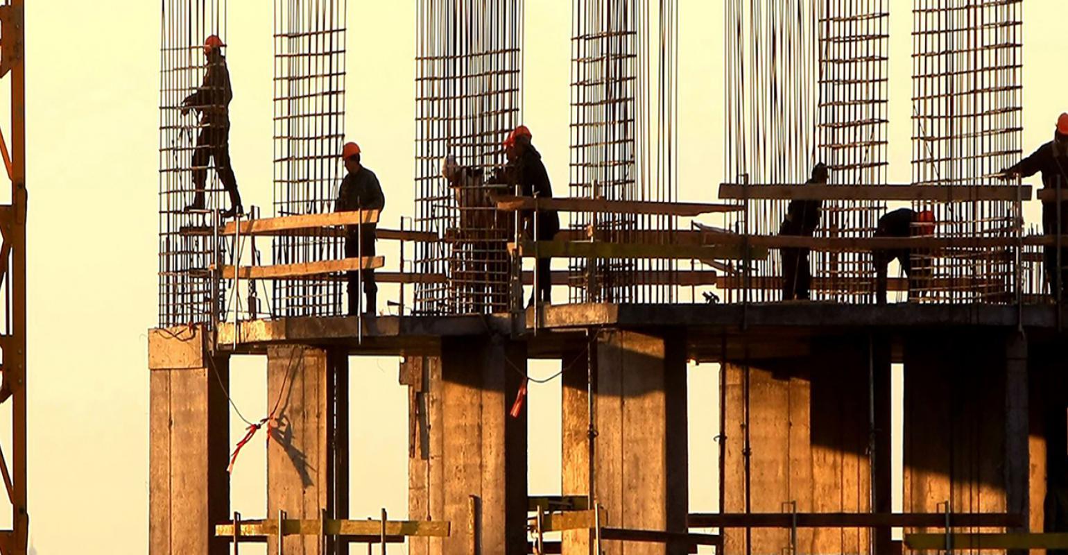 construction workers with rebar towers